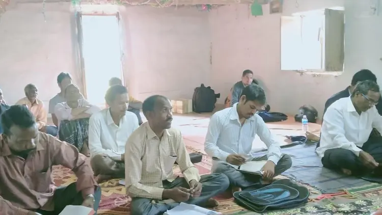 group of men sat on the floor in a meeting