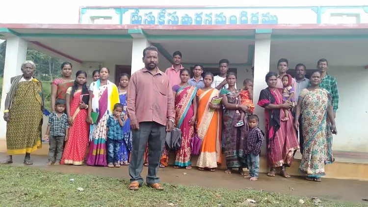 group photo taken outside a meeting hall